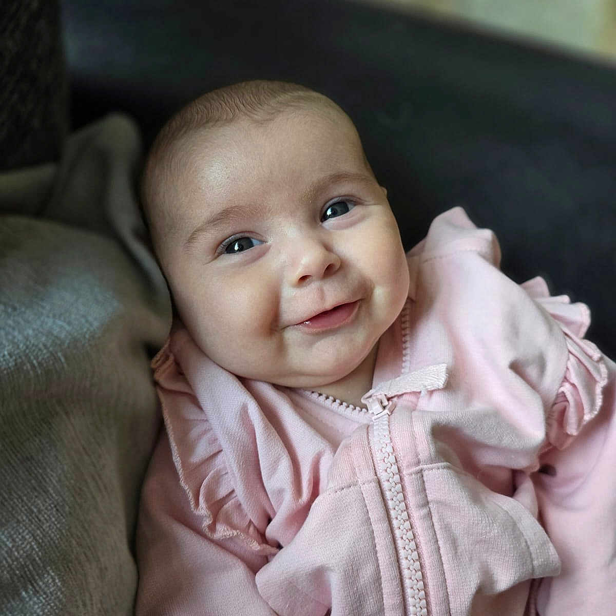 Layla joined the competition — help win amazing prizes! accessories, baby, babylaughing, blanket, blonde, clothing, coat, face, hair, happy, head, jacket, jewelry, necklace, newborn, person, photography, portrait, sleeve, smile