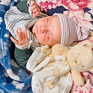 Ahad joined the competition — help win amazing prizes! baby, newborn, sleeping, blanket, hat, teddy_bear, soft_toy, cozy, infant, clothing, hand, face, peaceful, pink, blue, floral_pattern, striped, cute, resting, portrait