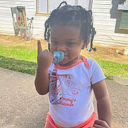 Nevaeh is registered to the contest to win money with this photo: toddler, child, pacifier, braided_hair, hand_holding, outdoor, sidewalk, house, grass, white_shirt, orange_pants, baby, cute, playful, person, daylight, smile, portrait, young_child, casual_clothing