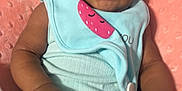 Cimani joined the competition — help win amazing prizes! baby, infant, child, headwrap, mint_green, pink_cushion, blanket, clothing, face, skin, hands, legs, indoors, person, portrait, cute, soft_texture, comfort, seated, expression