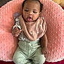 Cimani is registered to the contest to win money with this photo: baby, infant, pink_pillow, bib, flower_hair_clip, mint_green_pants, white_socks, flower_socks, tongue_out, cute, soft_texture, floral_top, lying_down, cozy, indoor, playful, child, person, adorable, comfortable
