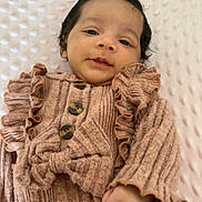 Alya participe au concours pour gagner de l'argent avec cette photo : baby, infant, newborn, child, portrait, ruffle_dress, bow, black_hair, blue_eyes, face, hand, blanket, textured_background, buttons, cozy, lying_down, closeup, expression, cute, soft_lighting