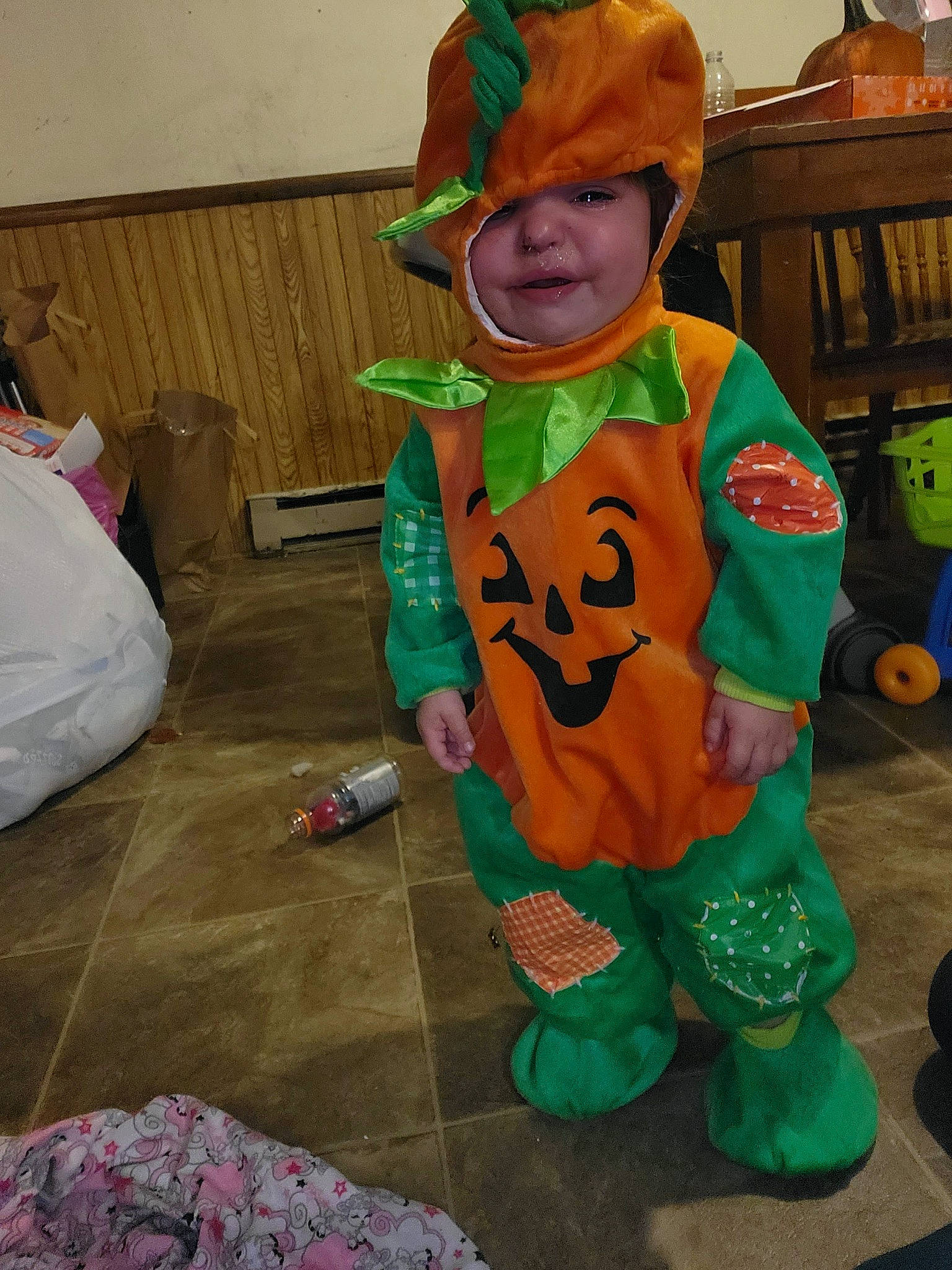 Zaharia joined the competition — help win amazing prizes! baby, bench, child, costume, event, fictional_character, flooring, fun, green, hat, headwear, holiday, hoodie, person, personal_protective_equipment, plastic_bag, play, room, sitting, toddler