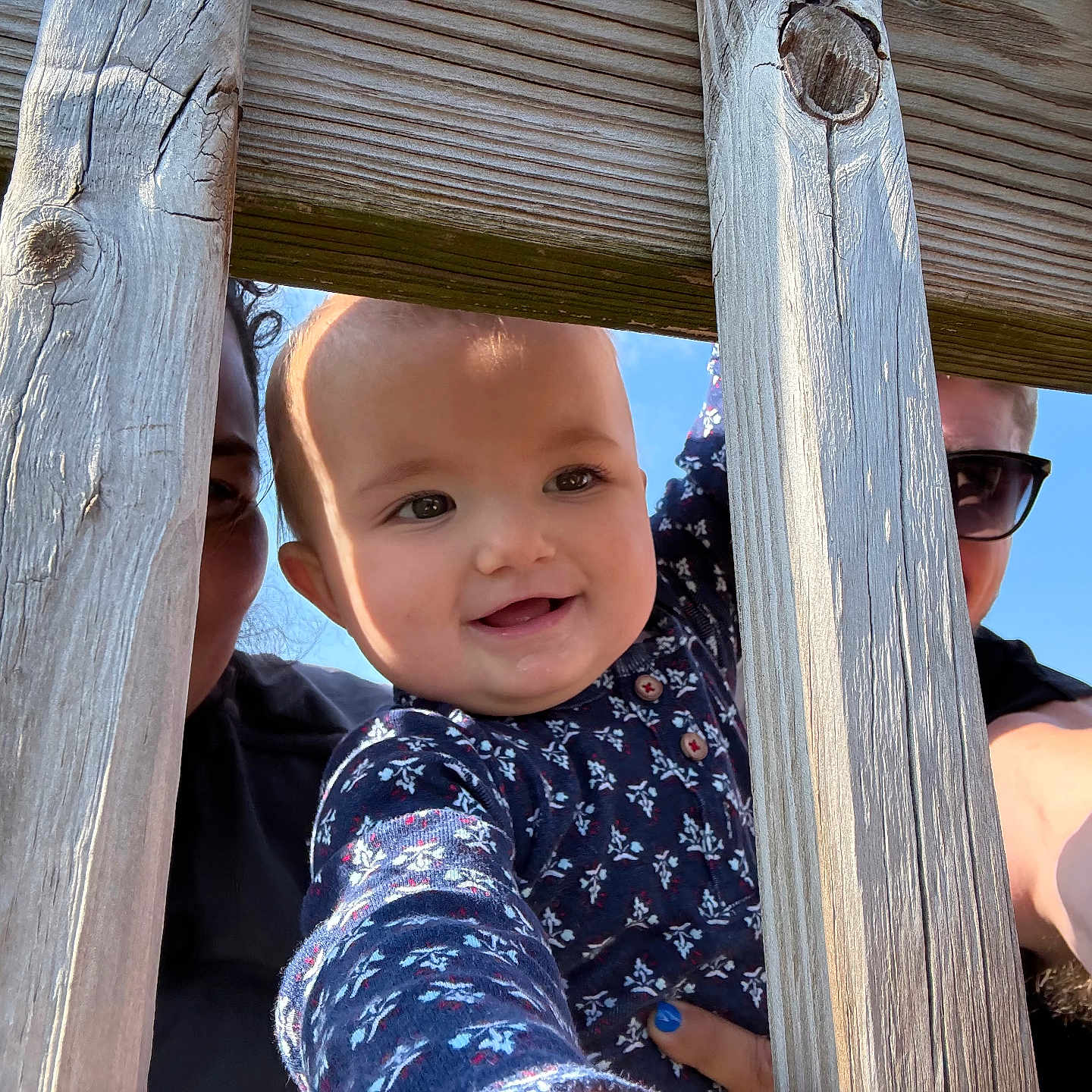 Anya is registered to the contest to win money with this photo: accessories, adult, baby, bodypart, face, fence, glasses, happy, head, male, man, mouth, outdoors, person, photography, playarea, portrait, sunglasses, teeth, wood