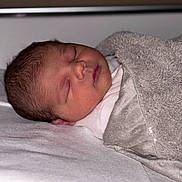 Mia participe au concours pour gagner de l'argent avec cette photo : baby, bed, blanket, closeup, cozy, delicate, face, head, indoors, infant, newborn, peaceful, portrait, quiet, resting, skin, sleeping, soft, wrapped, young