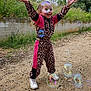Kelya a rejoint le concours — aidez-le/la à gagner de superbes lots ! child, girl, bubbles, outdoor, joyful, playful, leopard_print, jumpsuit, sneakers, grass, concrete_wall, smiling, happy, nature, fun, casual_clothing, daylight, dirt_path, arms_up, active