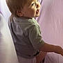 toddler, child, smiling, grey_shirt, blond_hair, indoors, sitting, portrait, side_view, soft_lighting, baby, young_child, cute, happy, face, person, casual_clothing, background, purple, light