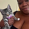 Stormi joined the competition — help win amazing prizes! animal, black_clothing, cat, close_up, cute, domestic_animal, face, feline, hand, holding, human, indoor, kitten, looking, person, pet, purple_collar, skin, tabby_cat, young_cat