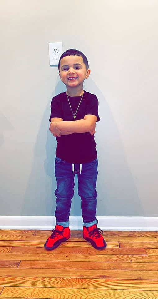 Jovanni is registered to the contest to win money with this photo: cool, denim, face, floor, flooring, footwear, hardwood, jeans, joint, joy, knee, leg, person, purple, shoulder, sleeve, smile, sneakers, standing, t_shirt