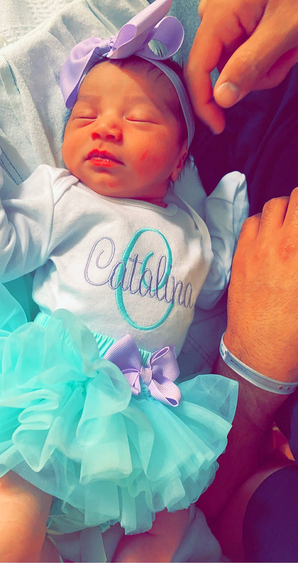 Catalina is registered to the contest to win money with this photo: azure, baby, baby_sleeping, baby_toddler_clothing, blue, cloud, comfort, cool, face, finger, gesture, green, hand, happy, headwear, morning, person, pink, textile, thumb