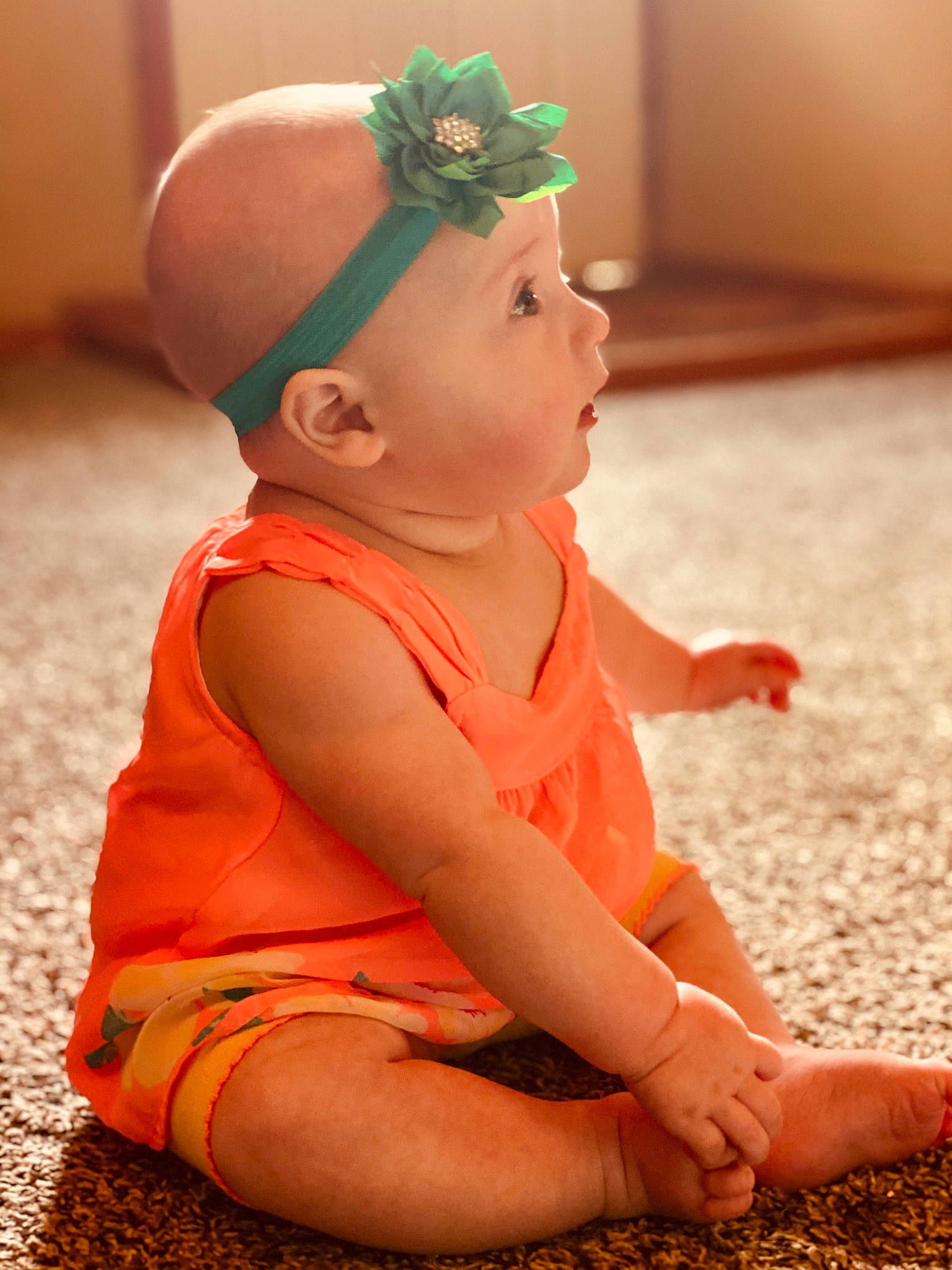 Hazley is registered to the contest to win money with this photo: baby, child, hair_accessory, hand, headband, headgear, leg, orange, person, sitting, toddler
