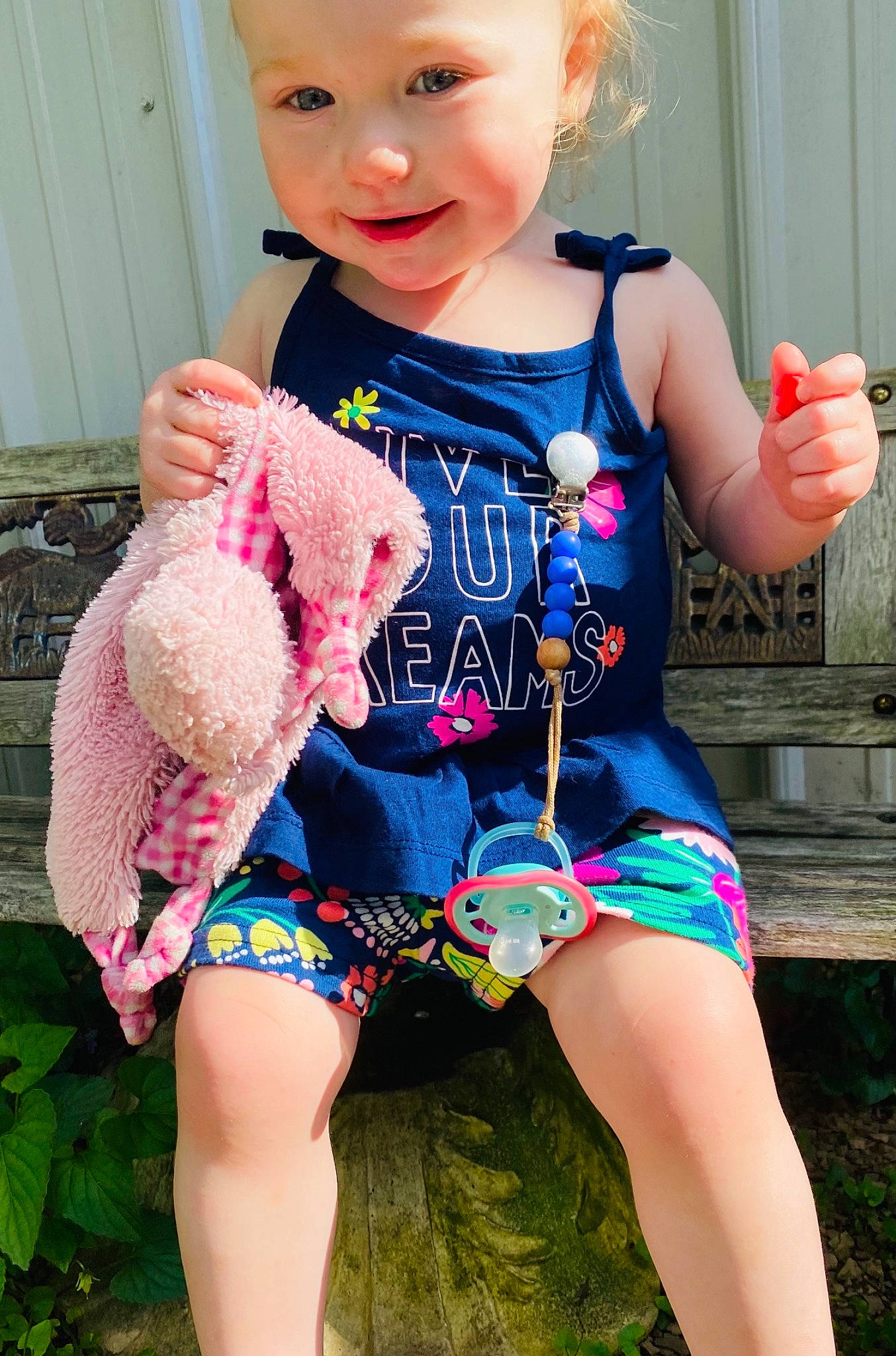 Hazley is registered to the contest to win money with this photo: baby_toddler_clothing, blue, clothing, dress, finger, grass, happy, headwear, leg, magenta, organ, person, pink, shoulder, skin, sleeve, smile, summer, textile, thigh