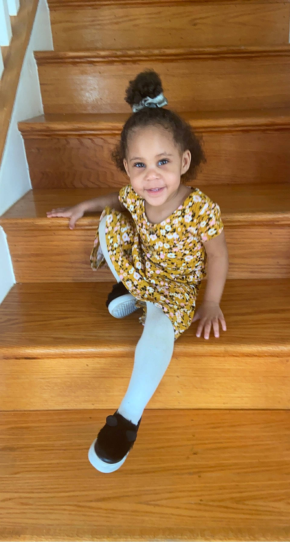 Leonnie is registered to the contest to win money with this photo: baby_toddler_clothing, dress, eye, face, floor, flooring, hair, happy, hardwood, head, joy, knee, neck, person, sleeve, smile, sportswear, standing, thigh, toddler
