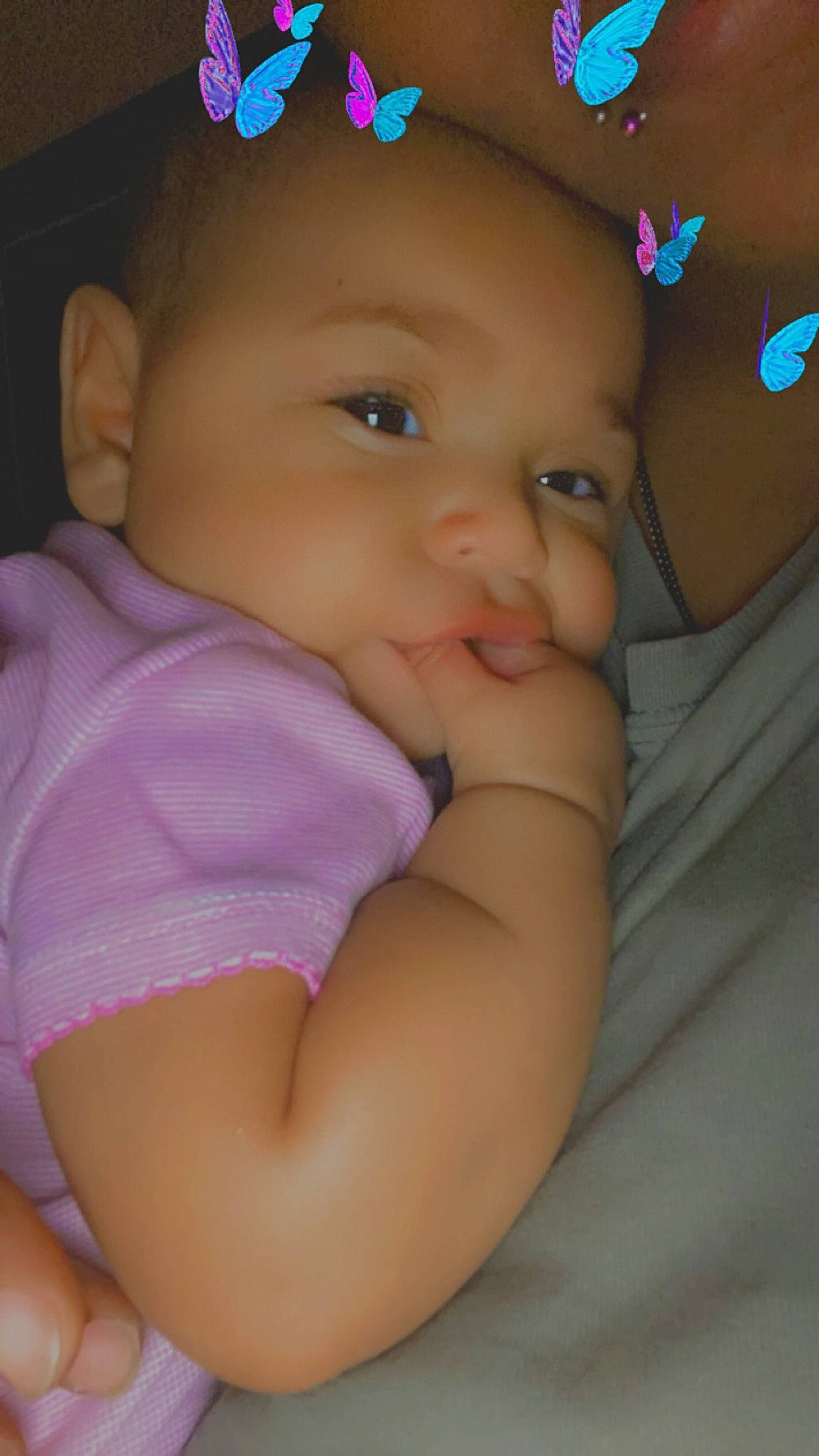 Meilani is registered to the contest to win money with this photo: baby, baby_toddler_clothing, cap, cheek, child, comfort, eye, finger, happy, headgear, human_body, iris, lip, mouth, nose, person, pink, purple, skin, sleeve