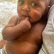 Maleek joined the competition — help win amazing prizes! arm, baby, child, closeup, cute, expression, eyes, face, fingers, hand, holding, human, infant, outdoor, person, shorts, sitting, skin, striped_clothing, torso