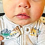 baby, child, face, eyes, mouth, clothing, onesie, zipper, infant, portrait, cute, young, expression, skin, person, closeup, indoor, apparel, button, hoodie