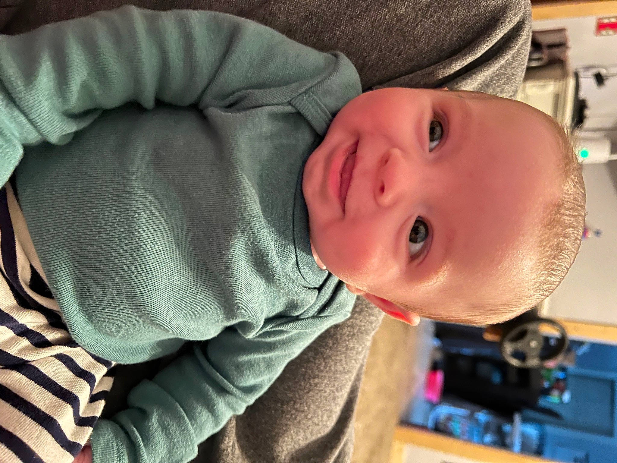 Cooper is registered to the contest to win money with this photo: baby, baby_toddler_clothing, cheek, child, chin, comfort, eyelash, facial_expression, happy, helmet, lip, mouth, nose, person, room, sitting, skin, sleeve, smile, toddler