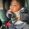 Saraii is registered to the contest to win money with this photo: baby, car_seat, casual, child, clothing, curious, cute, denim, face, fingers, hand, indoor, infant, pacifier, person, portrait, safety, seatbelt, sitting, young_child