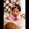Loëlya a rejoint le concours — aidez-le/la à gagner de superbes lots ! baby, infant, child, basket, flower_headband, pink_sweater, curly_hair, fluffy_blanket, indoor, portrait, cute, resting, decor, flowers, soft_lighting, closeup, skin, person, adorable, young