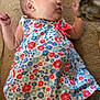 animal, arm, baby, carpet, cat, child, closeup, colorful, curious, dress, face, floor, floral_pattern, head, indoor, infant, interaction, leg, pet, skin