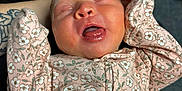 Helena joined the competition — help win amazing prizes! newborn, baby, sleeping, infant, floral_onesie, tattoo, arm, hand, black_leather, background, pink, clothing, person, cute, peaceful, mouth_open, indoor, closeup, resting, soft
