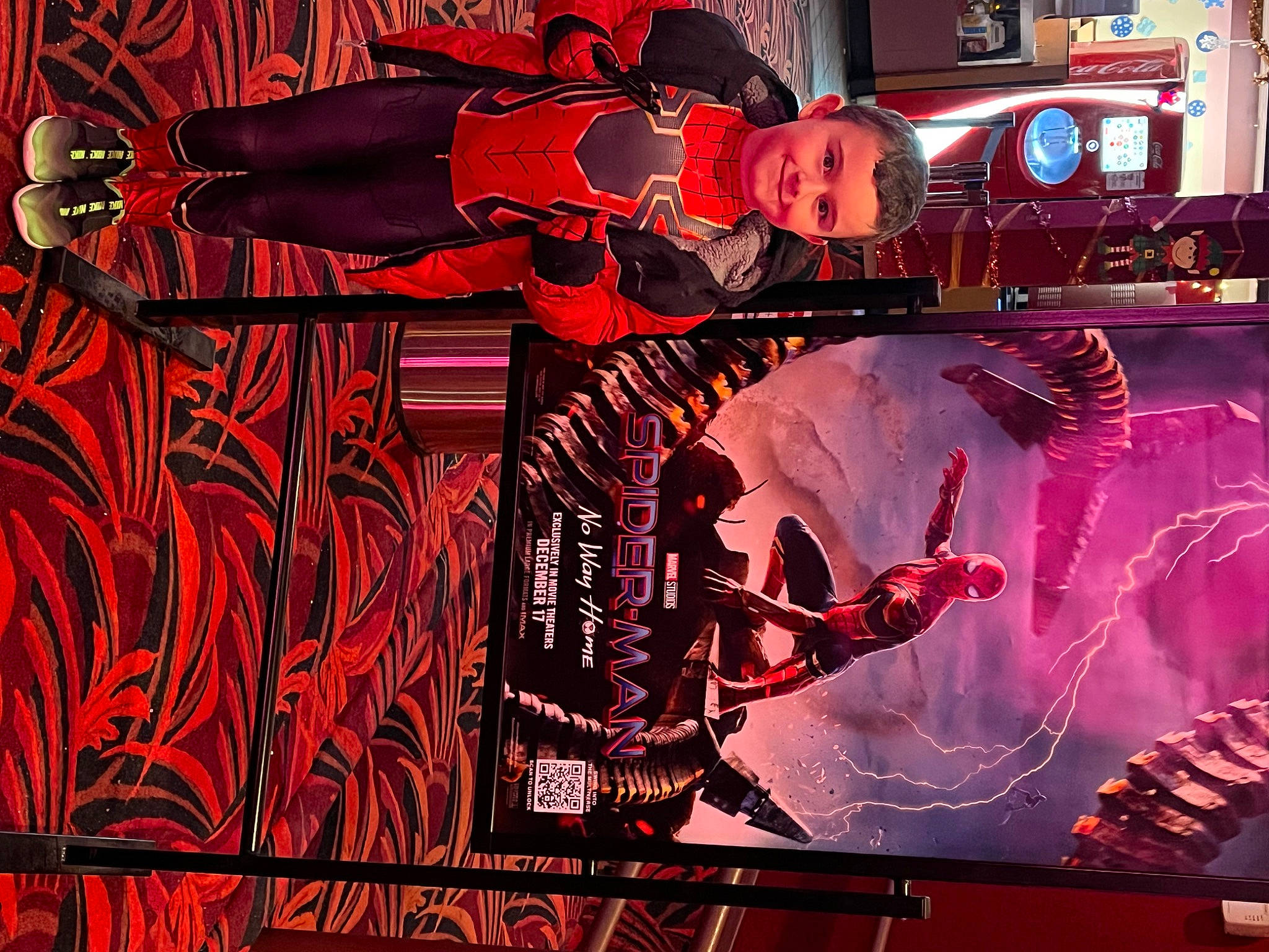 Draven is registered to the contest to win money with this photo: advertising, art, display_device, event, fictional_character, font, graphic_design, graphics, joy, machine, magenta, motor_vehicle, neon, person, red, visual_arts