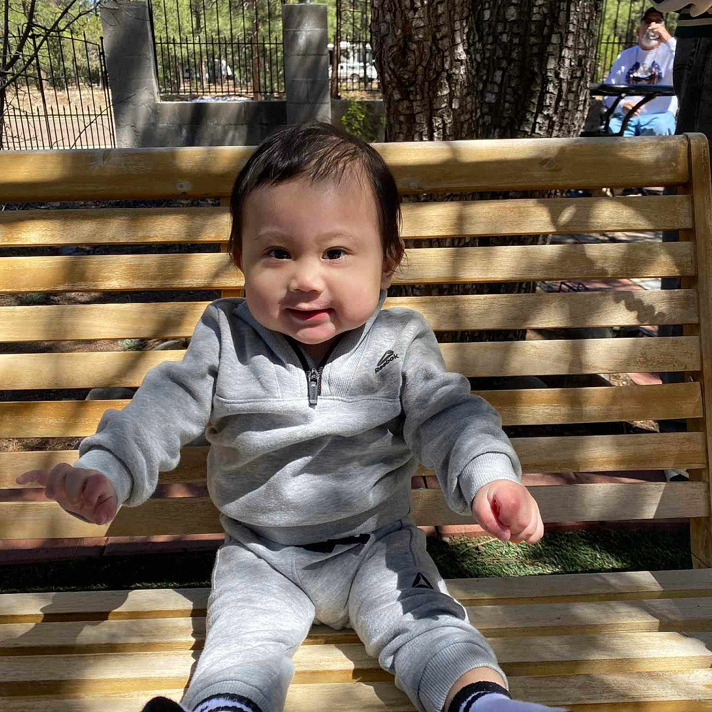 Asher joined the competition — help win amazing prizes! bench, clothing, face, footwear, furniture, grass, head, hosiery, nature, outdoors, pants, park, person, photography, plant, portrait, shoe, sitting, sock, wood