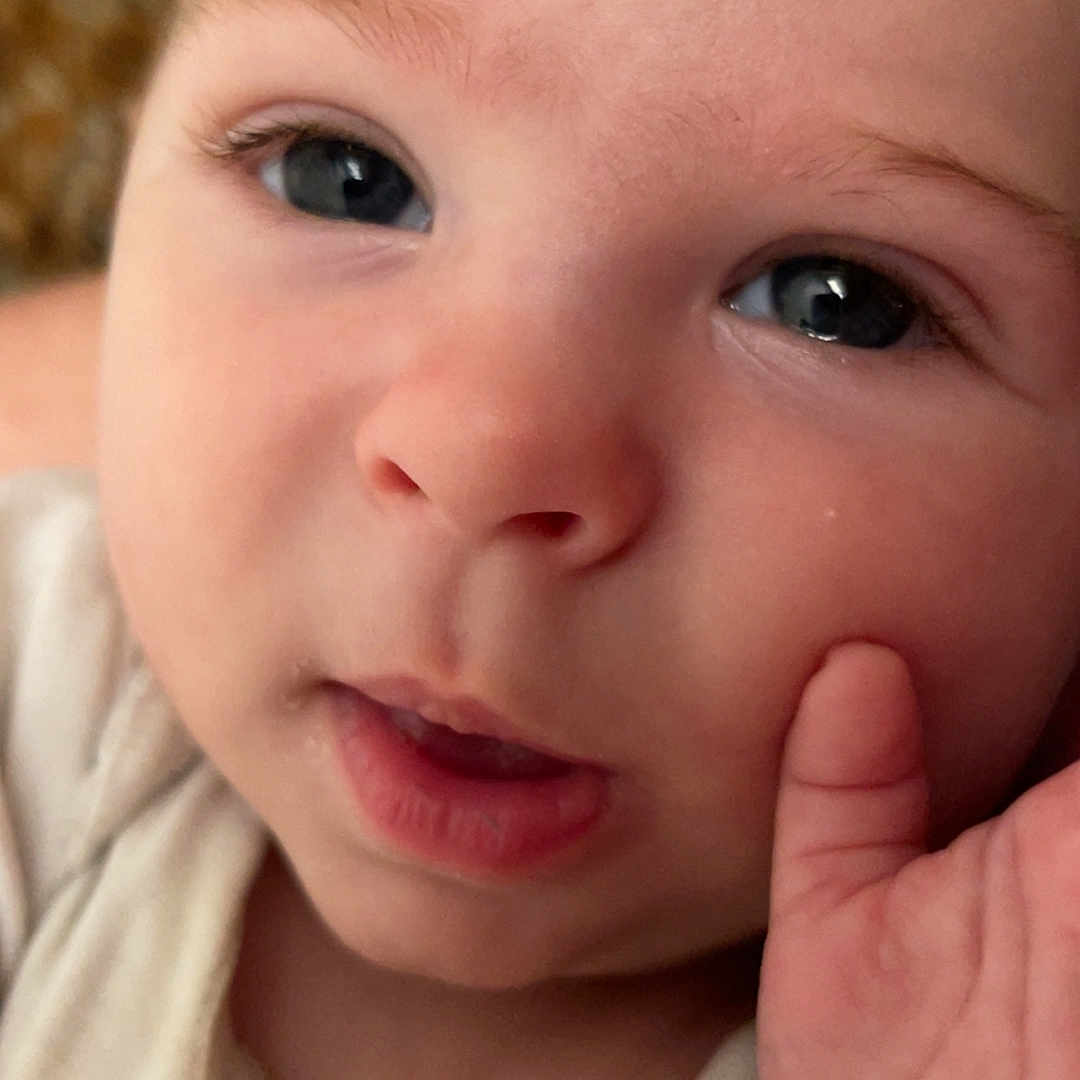 Kaysen joined the competition — help win amazing prizes! baby, closeup, face, hand, skin, eyes, infant, child, portrait, cute, soft, expression, fingers, young, human, looking, indoors, cozy, person, childhood