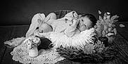 Aria participe au concours pour gagner de l'argent avec cette photo : baby, infant, wooden_bed, fluffy_pillow, flowers, vase, blanket, knit_sweater, portrait, black_and_white, soft_texture, decor, cozy, cute, newborn, lying_down, table, homedecor, peaceful, studio_photo