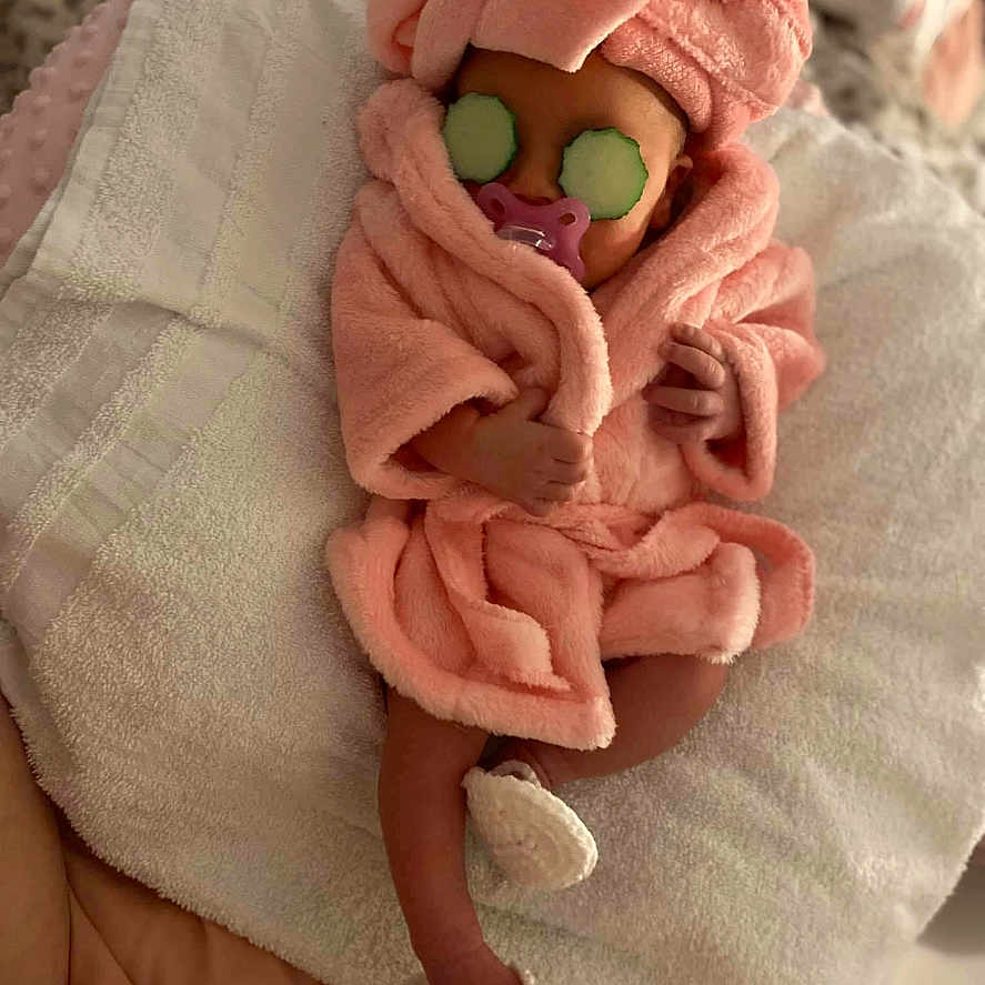 Nylayah is registered to the contest to win money with this photo: baby, blanket, bodypart, bonnet, cap, clothing, face, finger, glove, hand, happy, hat, head, hood, newborn, person, photography, portrait, sleeping, toy