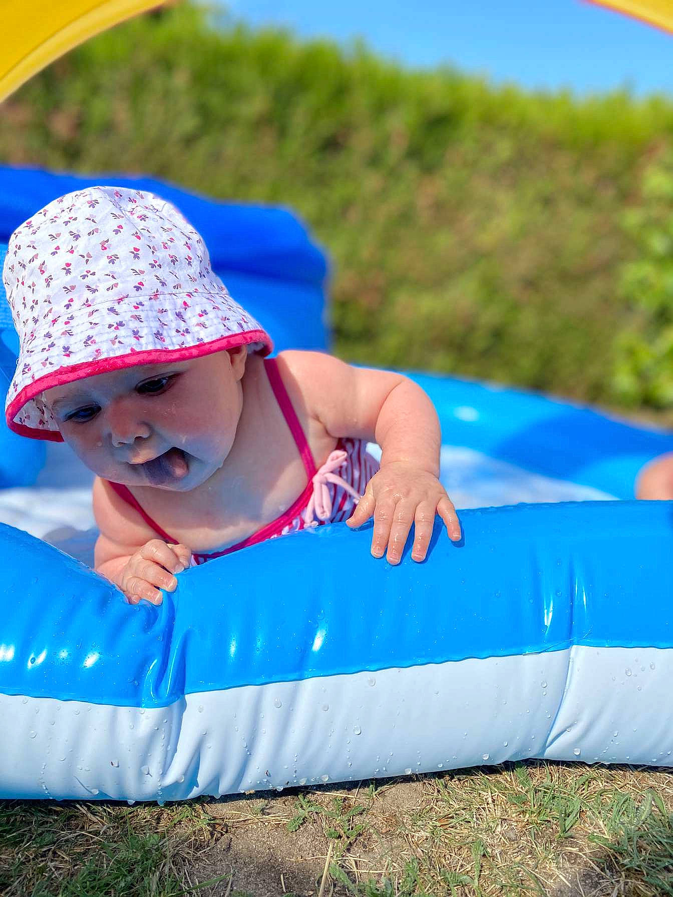 Neyla participe au concours pour gagner de l'argent avec cette photo : baby, blue, child, fashion_accessory, fun, games, grass, grassland, happy, headgear, headwear, lawn, leisure, person, plant, play, recreation, skin, smile, summer