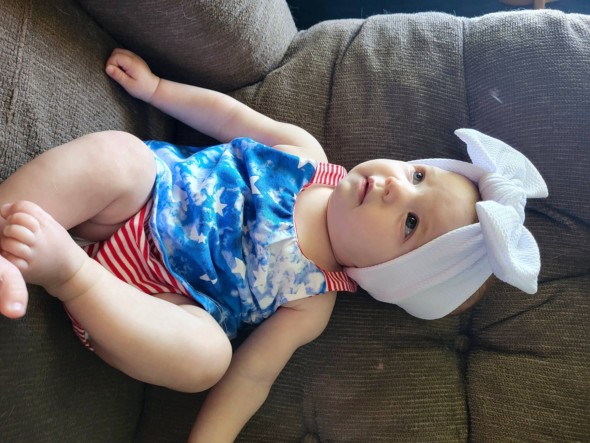 Mckenzie is registered to the contest to win money with this photo: arm, black_hair, child, comfort, elbow, eye, eyelash, facial_expression, flash_photography, grass, headwear, joint, knee, leg, lip, person, plant, shorts, shoulder, skin