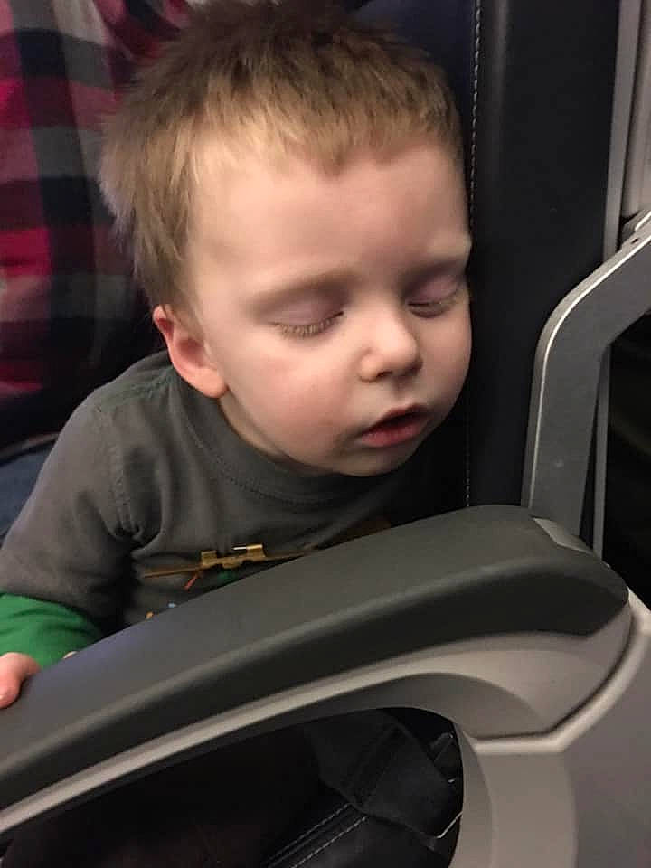 Ernest is registered to the contest to win money with this photo: auto_part, automotive_exterior, automotive_window_part, baby, baby_in_car_seat, car_seat, cheek, child, driving, ear, hairstyle, person, sitting, smile, toddler, vehicle, vehicle_door, windshield