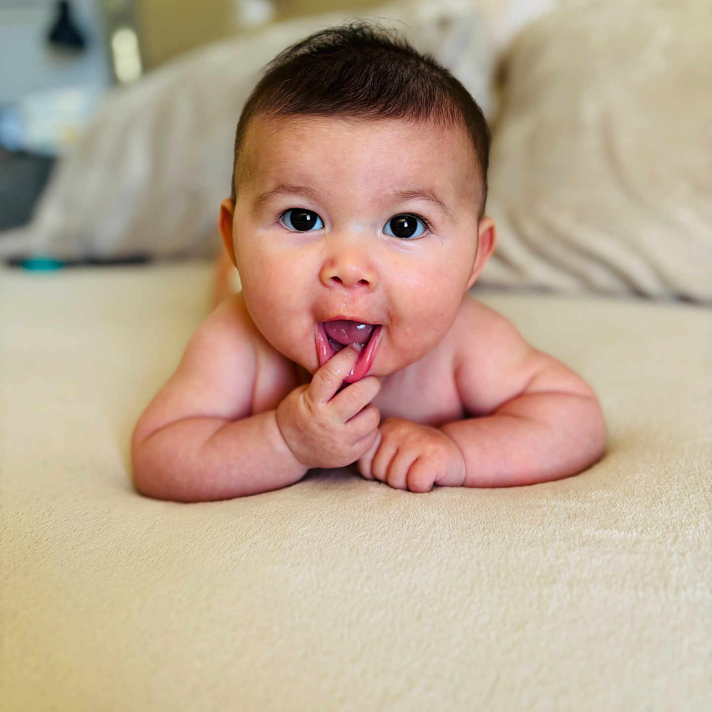 Mia is registered to the contest to win money with this photo: baby, bodypart, couch, eating, face, finger, food, furniture, hand, happy, head, indoors, mouth, newborn, person, photography, portrait, sitting, smile, toe