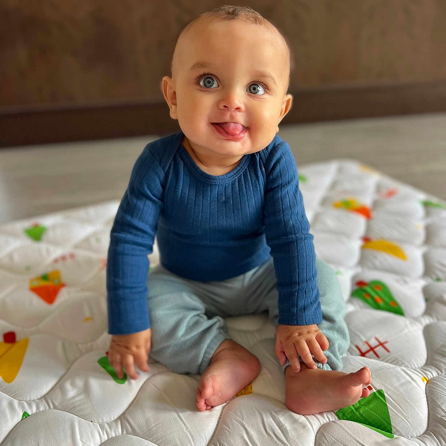 Grayson is registered to the contest to win money with this photo: baby, babycrawling, bed, bedroom, bodypart, clothing, crawling, face, finger, furniture, hand, happy, head, indoors, pants, person, photography, portrait, sitting, smile