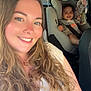 Ambre participe au concours pour gagner de l'argent avec cette photo : baby_toy, blond_hair, car, car_seat, casual_clothing, child, child_safety, curly_hair, daylight, family, happy, interior, long_hair, portrait, safety, seatbelt, smile, toddler, woman, young_child