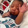 Hezekiah joined the competition — help win amazing prizes! newborn, baby, infant, sleeping, hospital, crib, blanket, swaddle, portrait, face, hand, raised_hand, feeding_tube, medical_tape, bedding, striped_blanket, dark_skin, peaceful, indoors, close_up