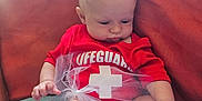 Atillia joined the competition — help win amazing prizes! baby, infant, red_clothing, lifeguard_onesie, tulle, blanket, cushion, indoors, cute, chubby_cheeks, sitting, looking_down, soft_light, skin, head, hand, legs, toddler, child, portrait