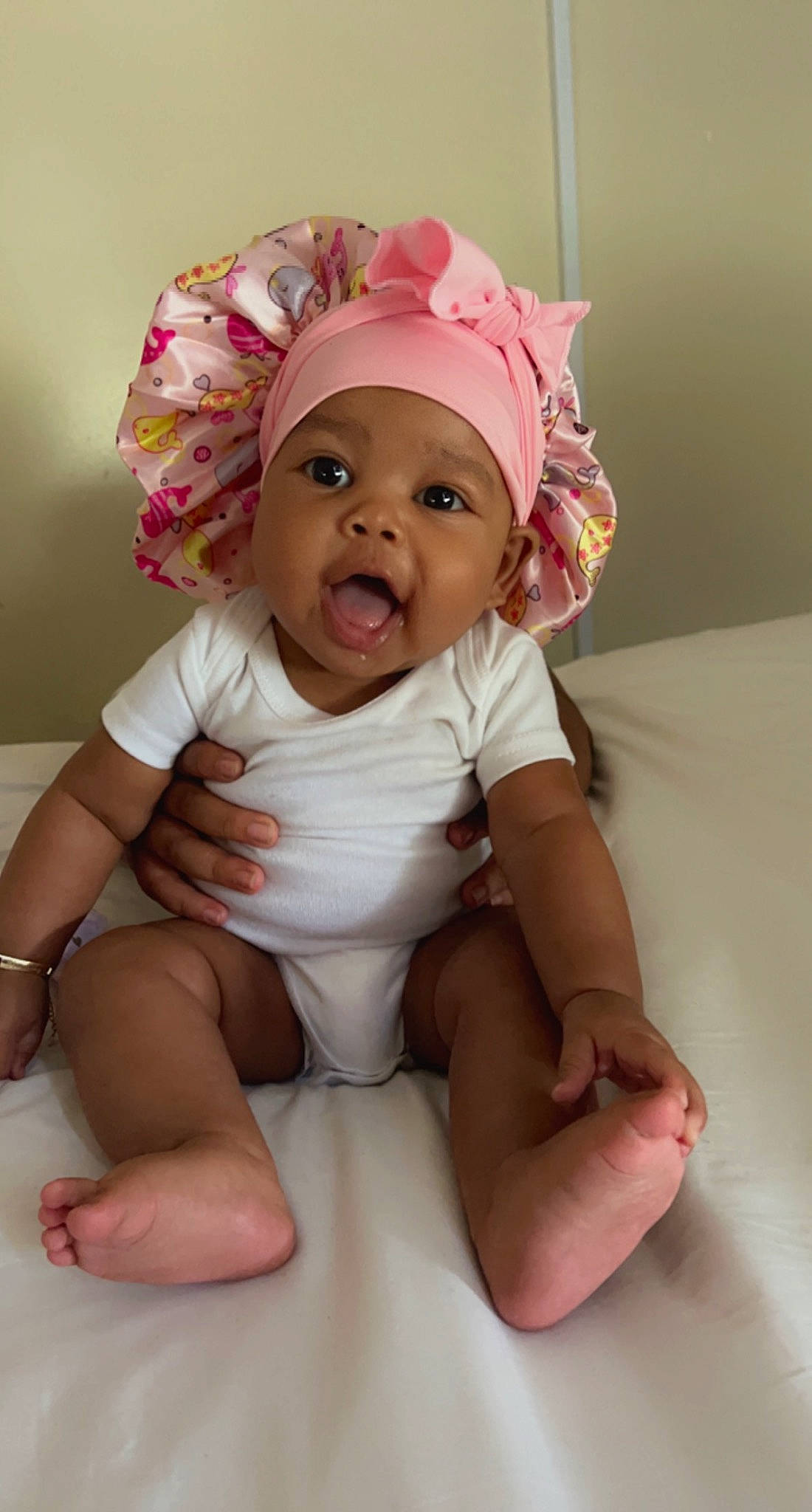 Harmony joined the competition — help win amazing prizes! baby, baby_toddler_clothing, cap, cheek, child, comfort, fashion_accessory, happy, headgear, headwear, human_body, human_leg, magenta, mouth, person, pink, room, sitting, skin, sleeve