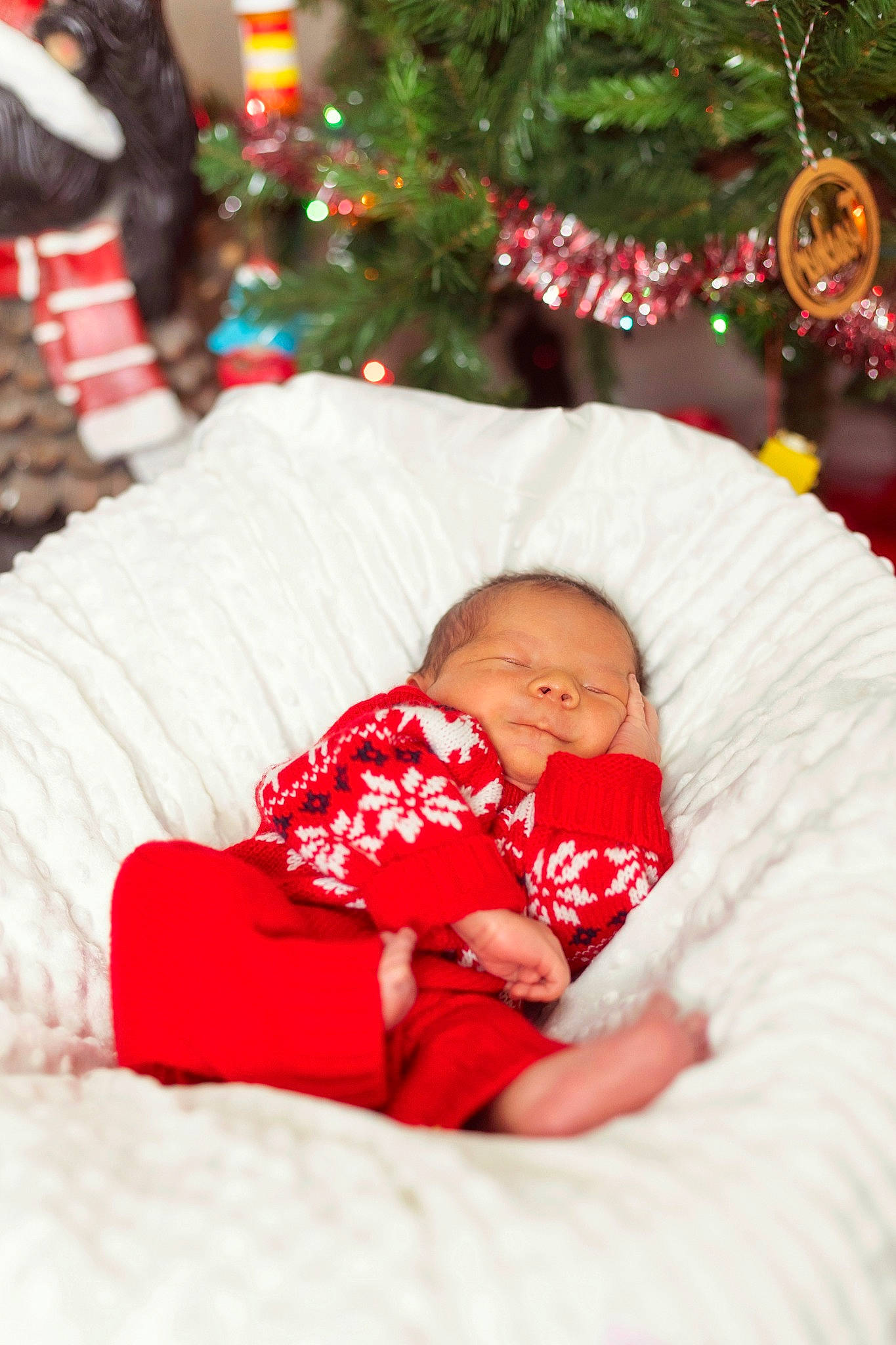 Hayes is registered to the contest to win money with this photo: baby, baby_toddler_clothing, child, christmas, christmas_decoration, christmas_ornament, christmas_tree, comfort, event, eye, green, happy, holiday, holiday_ornament, ornament, person, red, room, skin, toddler