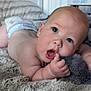 baby, infant, diaper, blanket, plush_toy, hand, face, skin, mouth, eye, indoor, curious, soft_texture, lying_down, close_up, cute, child, toddler, newborn, expression