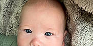 Ridley joined the competition — help win amazing prizes! baby, infant, face, blanket, pacifier, green_clothing, cozy, soft_texture, cute, lying_down, child, portrait, indoors, skin, head, expression, mouth, eyes, sleepwear, comfort