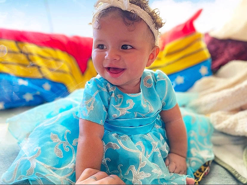 Stormie joined the competition — help win amazing prizes! aqua, baby, baby_toddler_clothing, child, dress, electric_blue, event, eye, face, fun, grass, happy, iris, leisure, pattern, person, product, recreation, smile, toddler