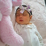 Aylani is registered to the contest to win money with this photo: baby, newborn, sleeping, onesie, headband, floral, stuffed_animal, pink, bunny, blanket, heart_pattern, soft, cozy, indoor, child, peaceful, cute, infant, resting, portrait