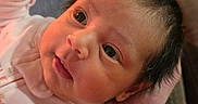Aylani is registered to the contest to win money with this photo: baby, child, closeup, clothing, cute, expression, eyes, face, hand, holding, indoor, infant, newborn, person, portrait, skin, soft_light, tattoo, warm, young