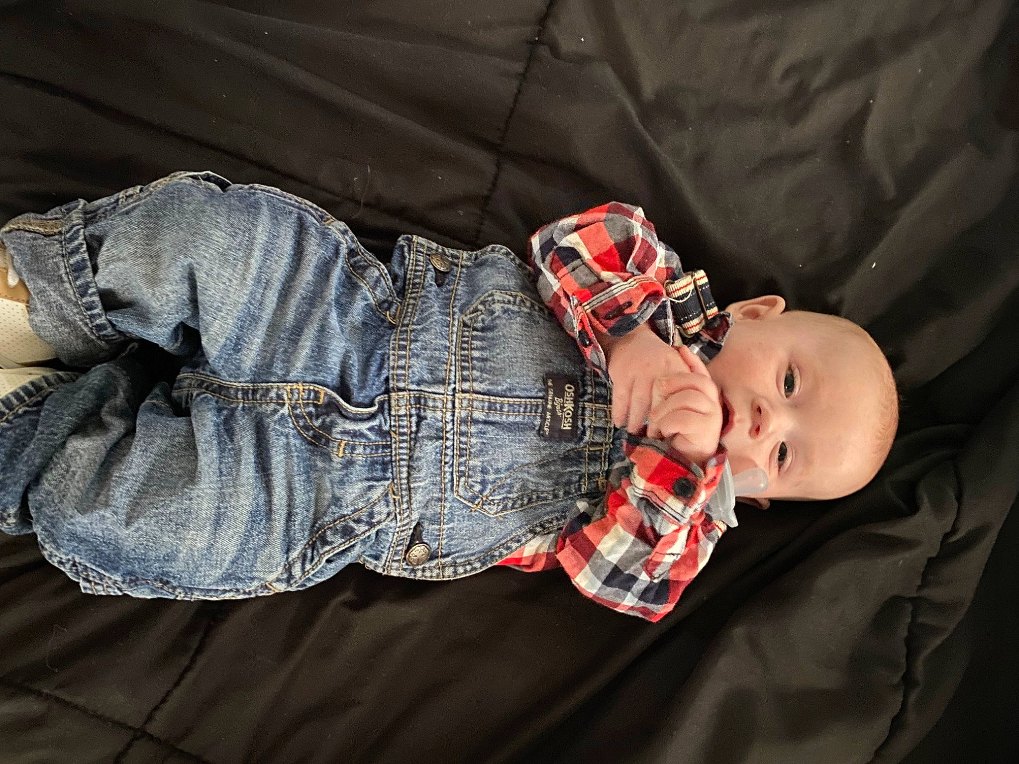 Tucker is registered to the contest to win money with this photo: abdomen, baby, baby_products, baby_toddler_clothing, carmine, child, clothing, comfort, human_body, human_leg, nail, pattern, person, plaid, sitting, skin, sleeve, tartan, textile, toddler
