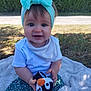 baby, blanket, bow, child, cute, grass, happy, headband, nature, outdoor, penguin, person, plush, portrait, skirt, smiling, socks, sunlight, toy, white_shirt