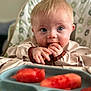 baby, child, high_chair, food, watermelon, snack, blue_eyes, face, hands, eating, indoor, close_up, cute, infant, feeding, plate, curious, healthy_food, blond_hair, person