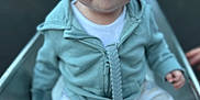 Finley joined the competition — help win amazing prizes! baby, child, slide, outdoor, playground, jacket, pants, sock, face, blue_eyes, sitting, curious, hand, toy, pacifier, light_blue, clothing, infant, young_child, nature