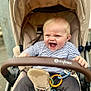 baby, stroller, laughing, child, toy_rings, pacifier, striped_shirt, beige, outdoor, happy, infant, clothing, seatbelt, grip, person, cute, expression, young_child, casual, transport